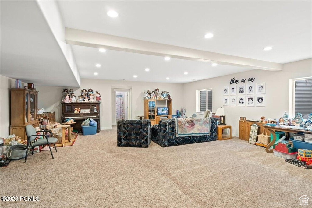 Carpeted living room featuring recessed lighting and beamed ceiling