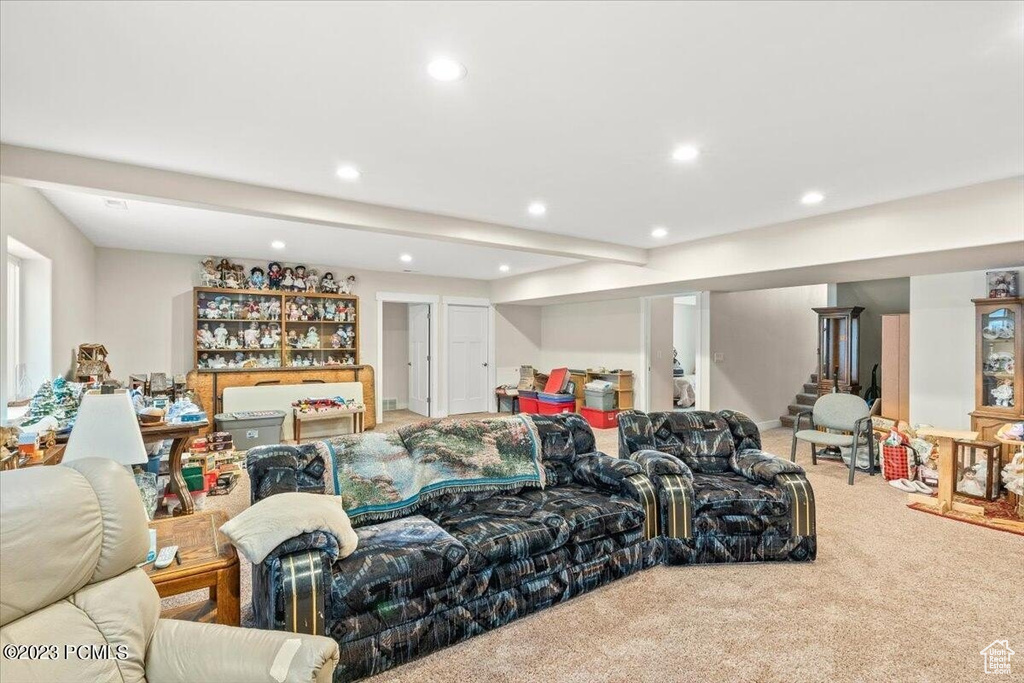 Living area with recessed lighting, carpet, and stairs