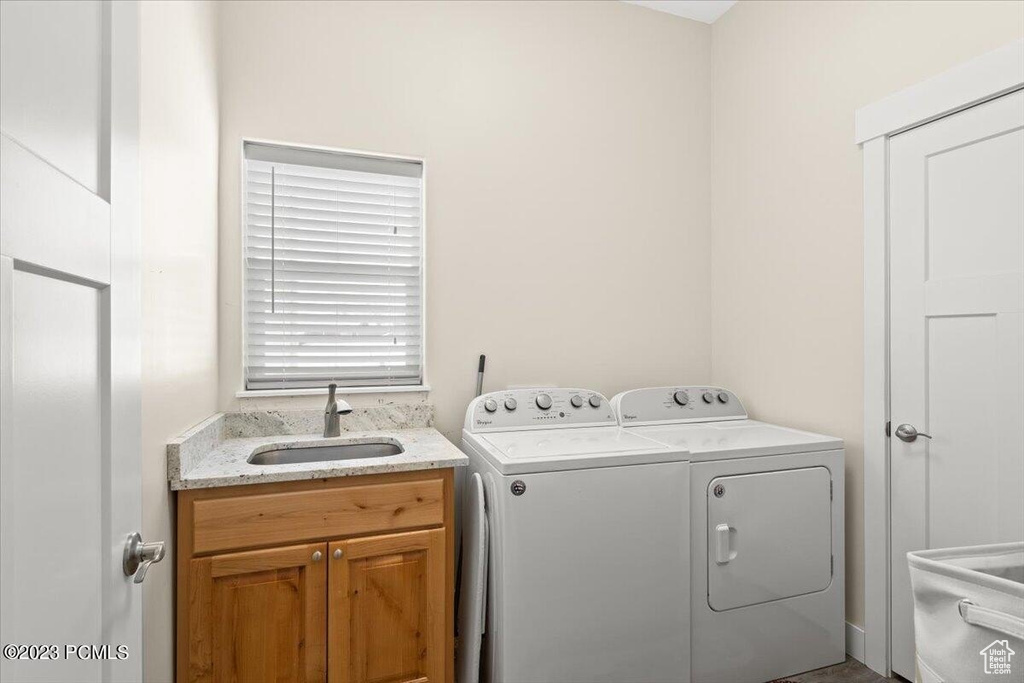 Laundry room with independent washer and dryer and cabinet space