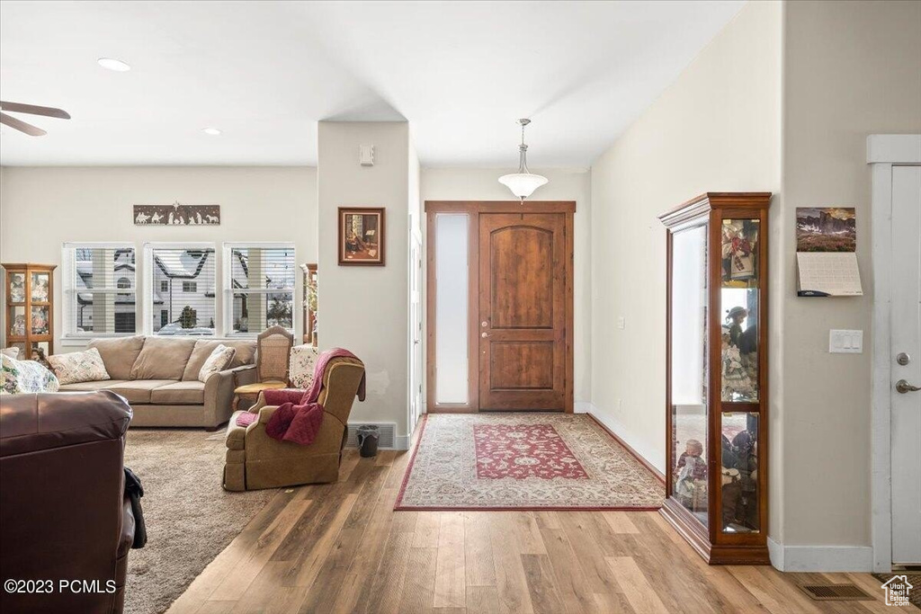 Foyer with wood finished floors and ceiling fan