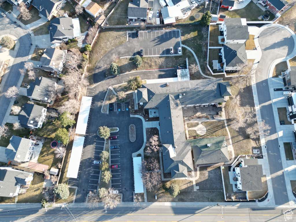 Aerial view of property and surrounding area with nearby suburban area