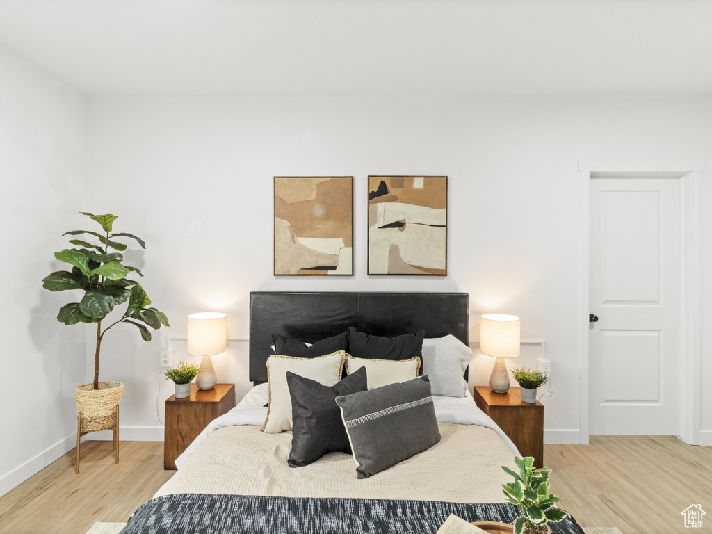 Bedroom featuring wood finished floors and baseboards