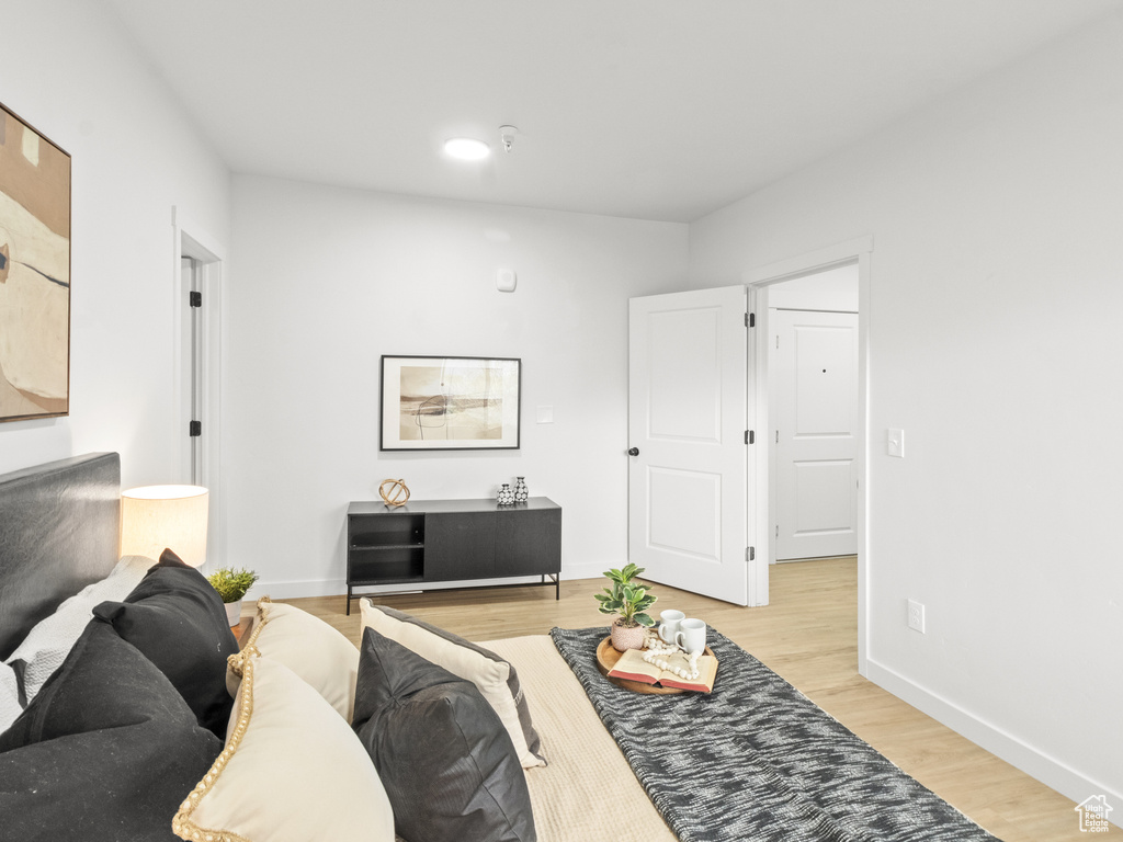 Living area with light wood-style floors and baseboards