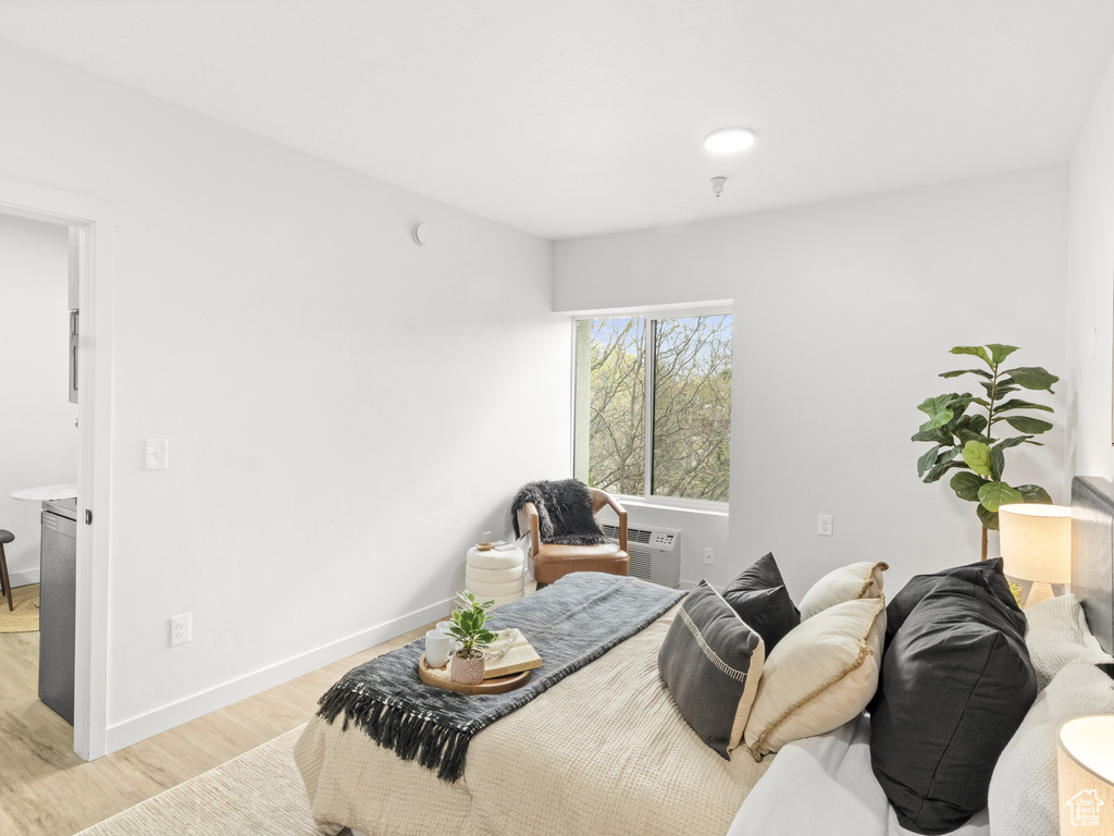 Bedroom with light wood-type flooring and baseboards