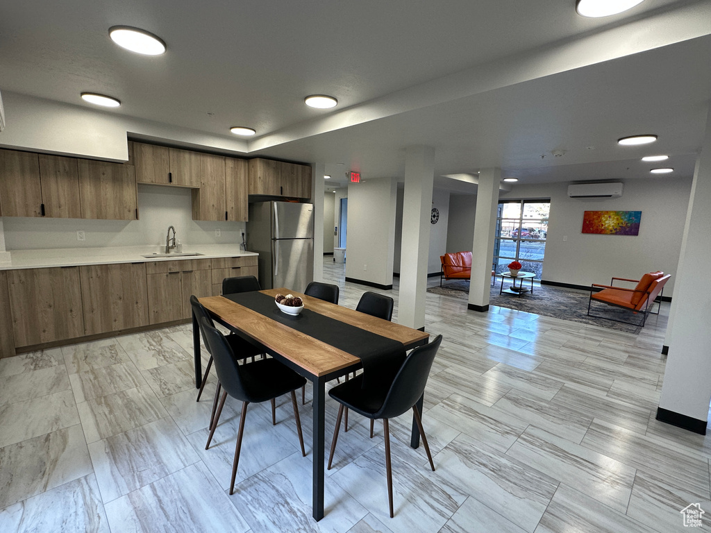 Dining area with an AC wall unit and baseboards