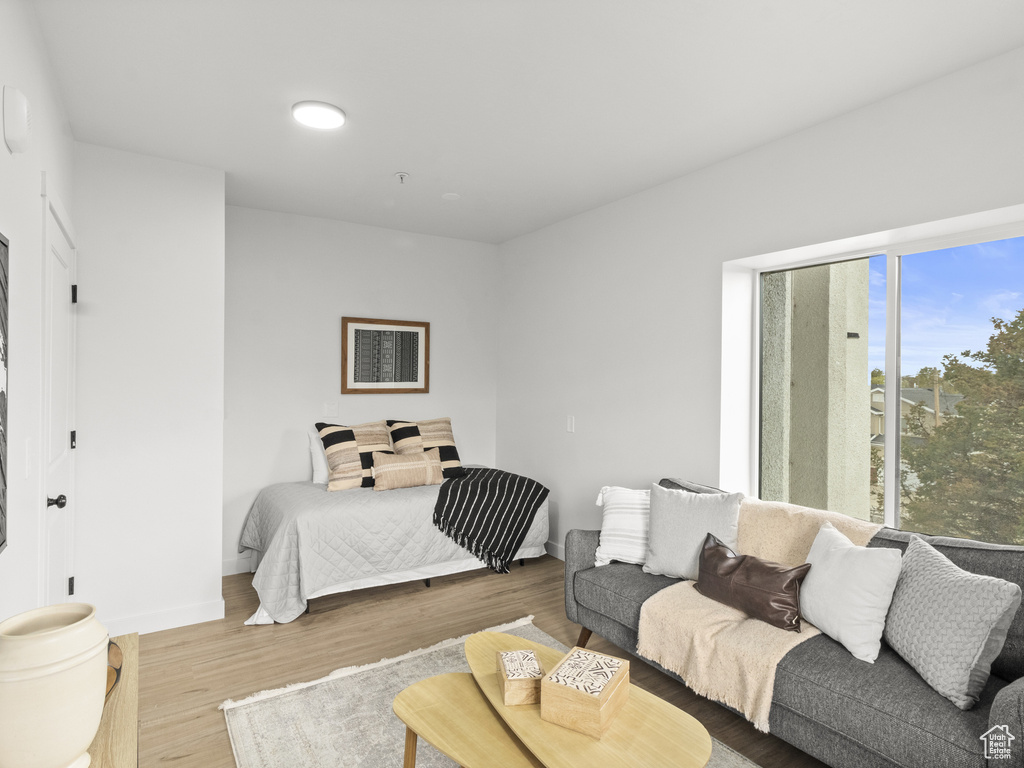 Bedroom featuring wood finished floors and baseboards