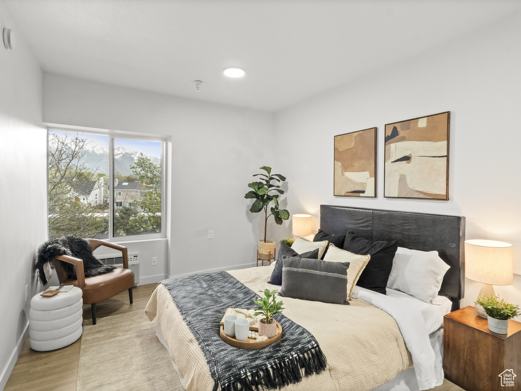 Bedroom featuring baseboards and wood finished floors