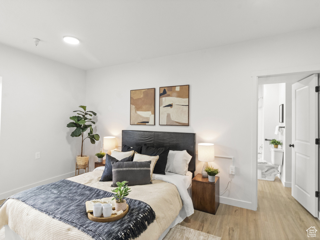 Bedroom featuring baseboards and wood finished floors