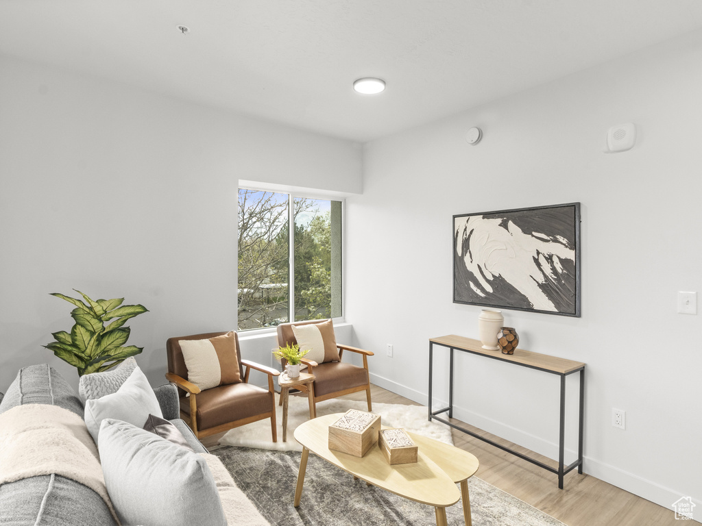 Living area featuring light wood-style floors and baseboards