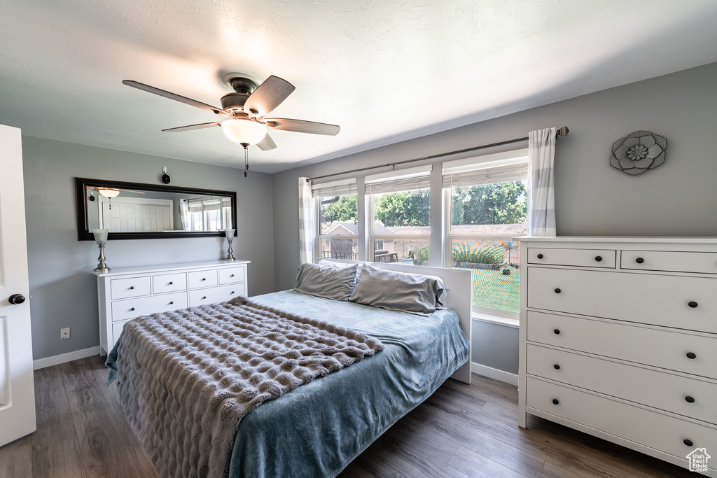 Bedroom with dark wood finished floors and ceiling fan