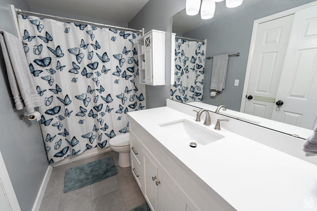 Full bathroom with vanity, a shower with curtain, and tile patterned flooring