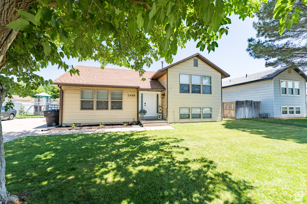 Split level home featuring a shingled roof