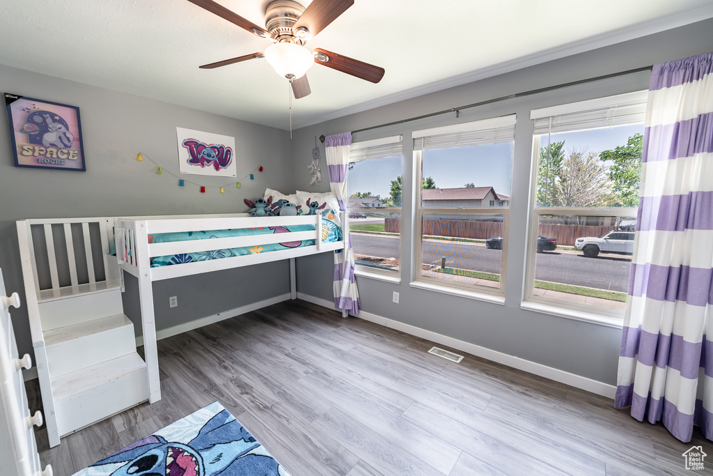 Bedroom featuring wood finished floors and ceiling fan