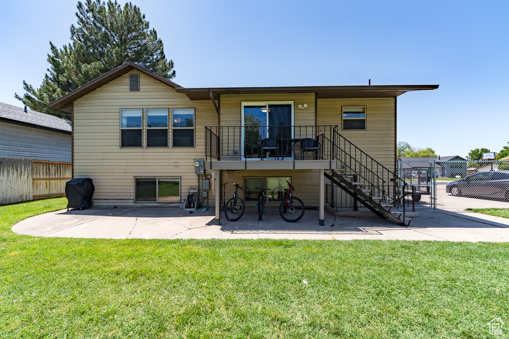 Rear view of house with a patio and stairs