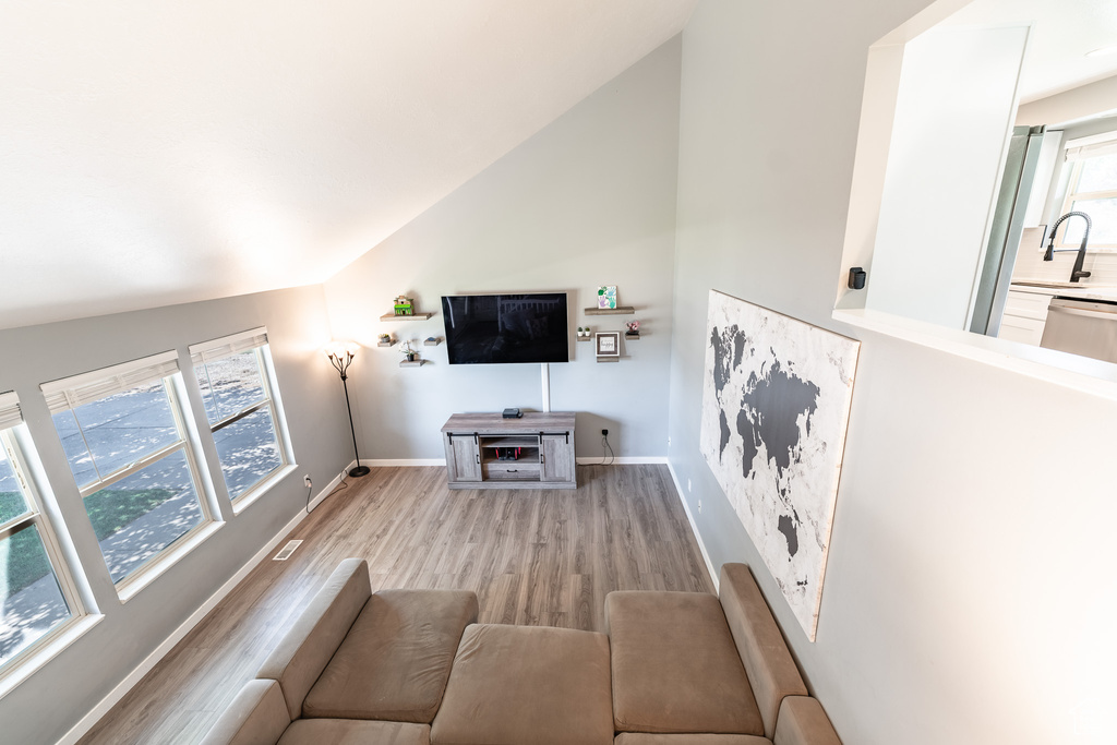Living area featuring lofted ceiling and wood finished floors