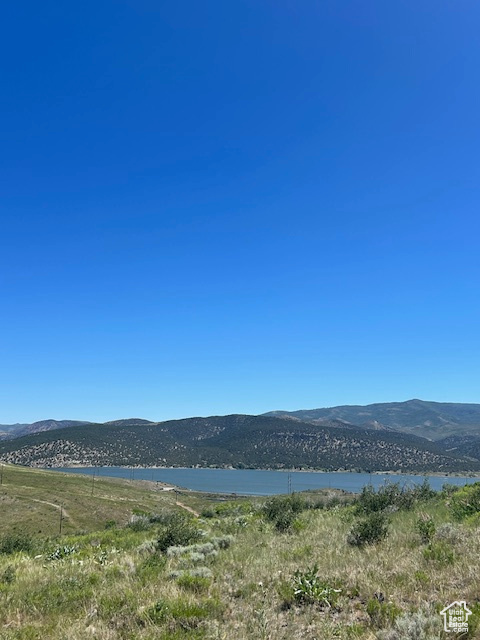 View of mountain backdrop featuring a nearby body of water