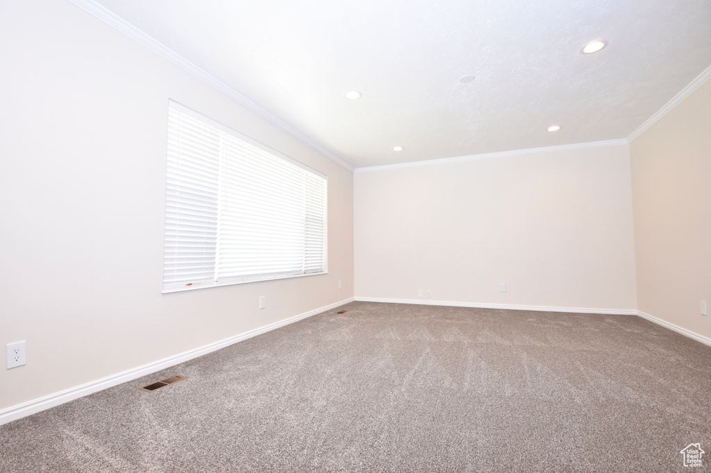 Spare room with ornamental molding, recessed lighting, and carpet flooring