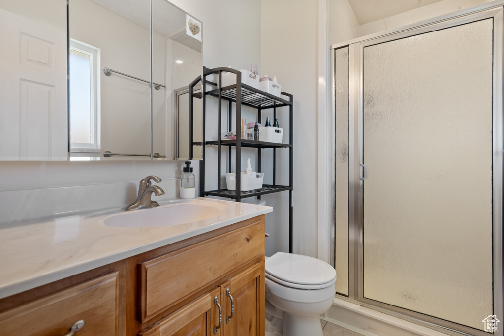 Full bath featuring a shower stall and vanity