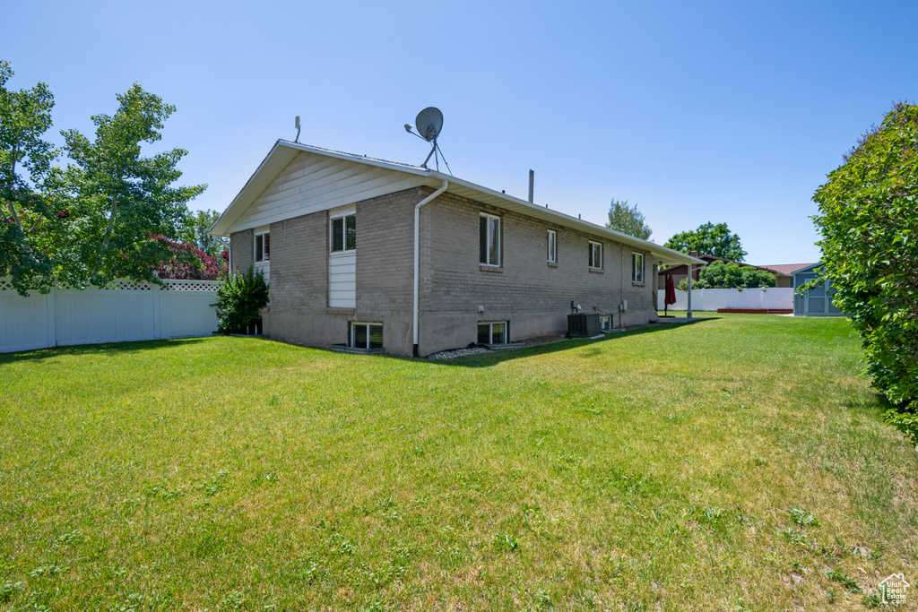 Rear view of property with brick siding