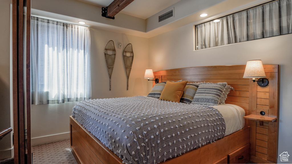 Bedroom featuring beam ceiling and baseboards