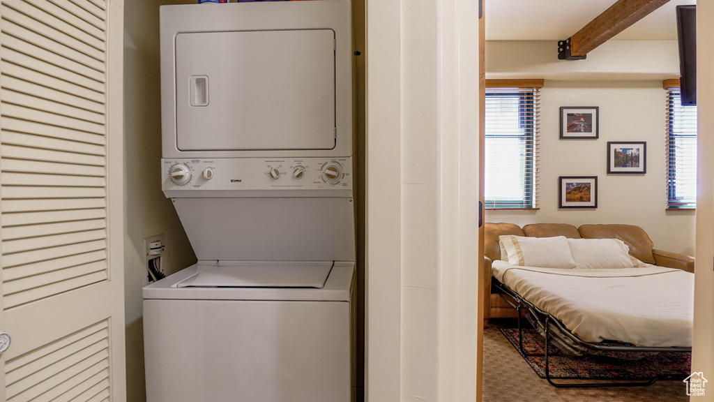 Washroom featuring stacked washer and clothes dryer