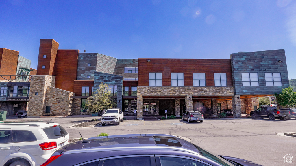 View of property featuring uncovered parking