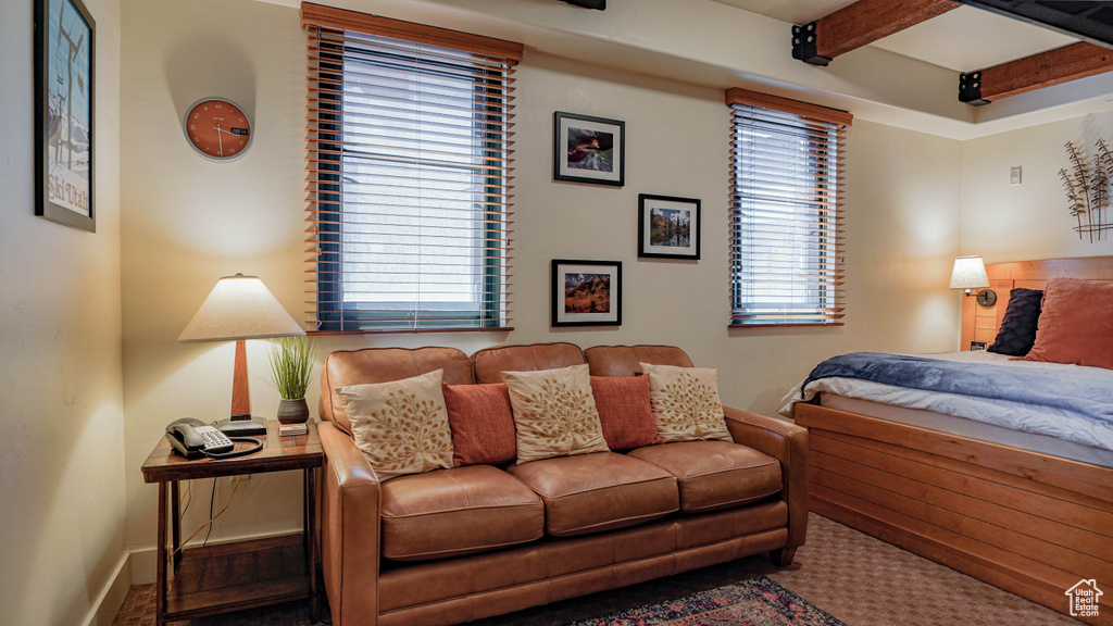 Bedroom featuring beamed ceiling and baseboards