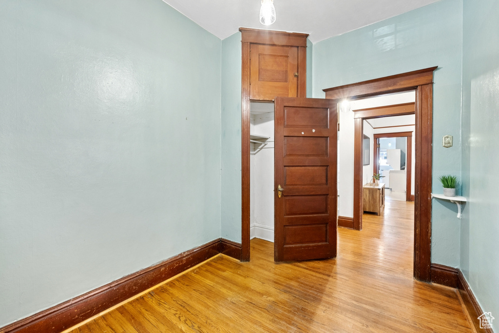 Unfurnished bedroom featuring light wood-style flooring and baseboards