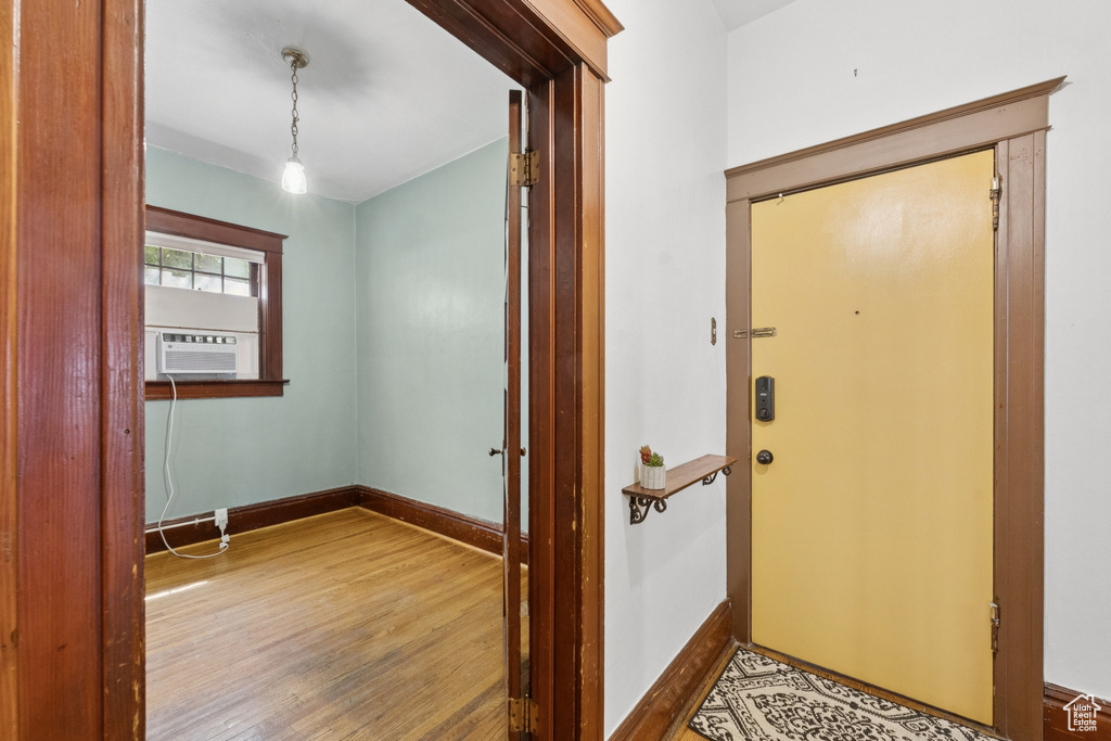 Foyer with wood finished floors and cooling unit