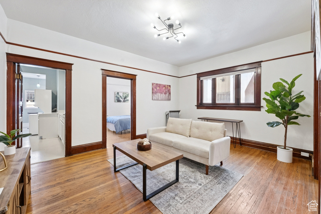 Living area with baseboards and light wood-type flooring