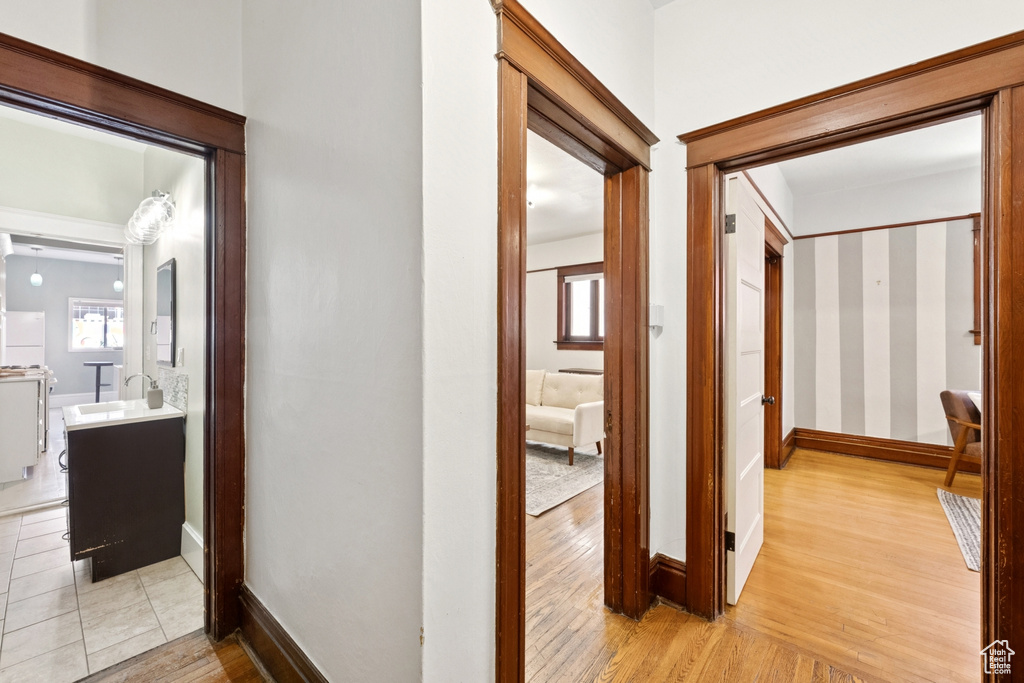 Hallway featuring light wood-style floors and baseboards