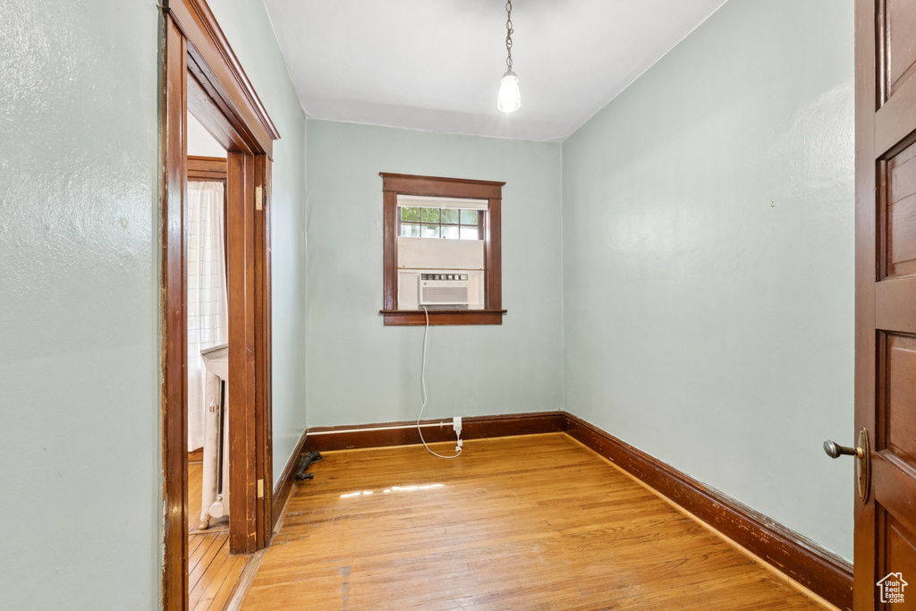 Unfurnished room with light wood-style floors and cooling unit