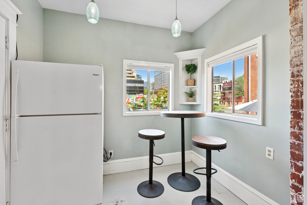 Kitchen with freestanding refrigerator and healthy amount of natural light