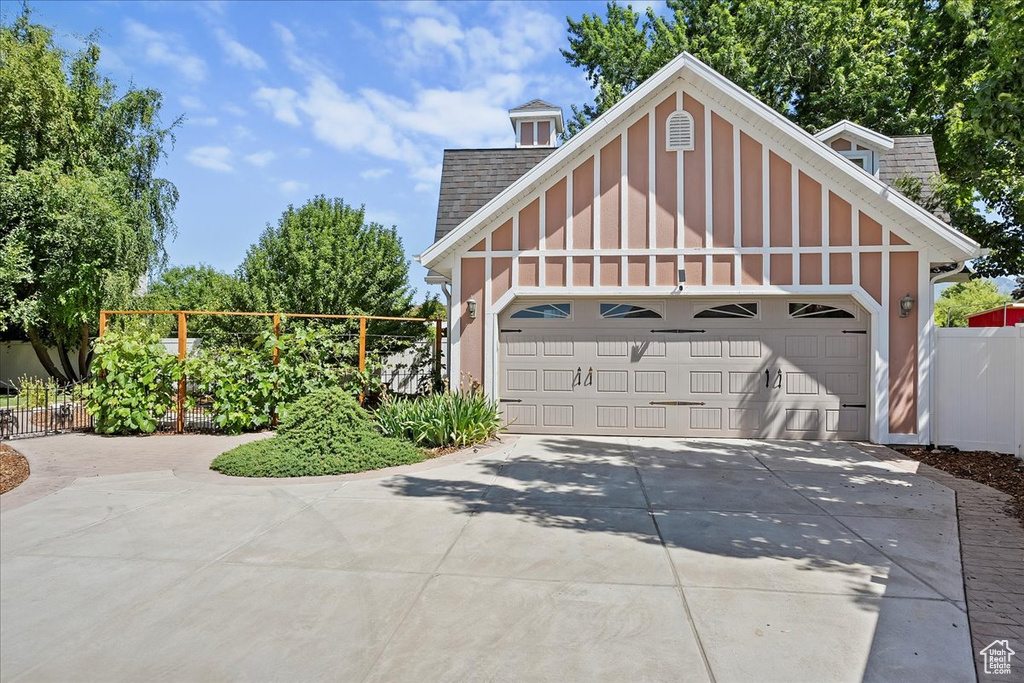 Garage featuring concrete driveway