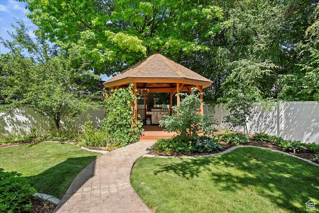 Fenced backyard with a gazebo