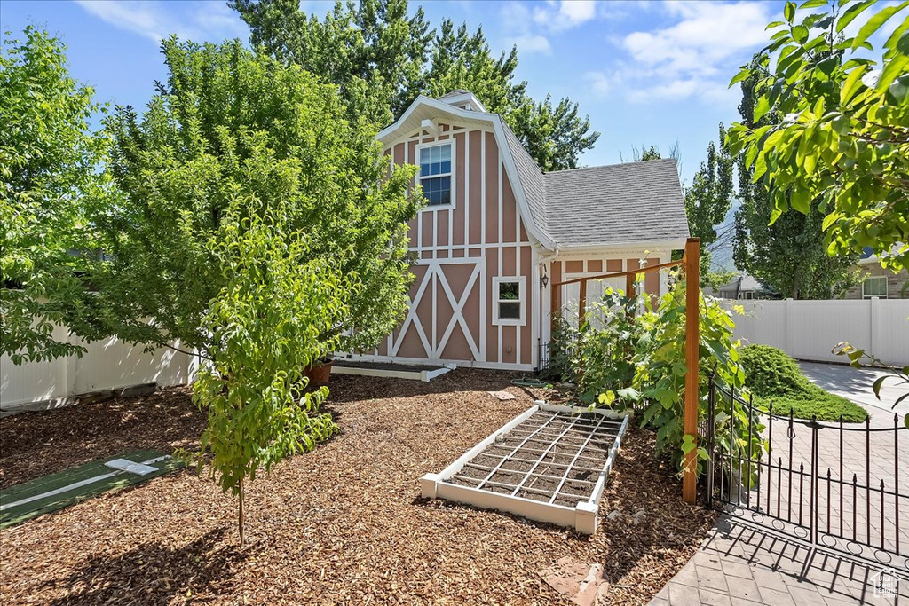 View of outbuilding with a gate