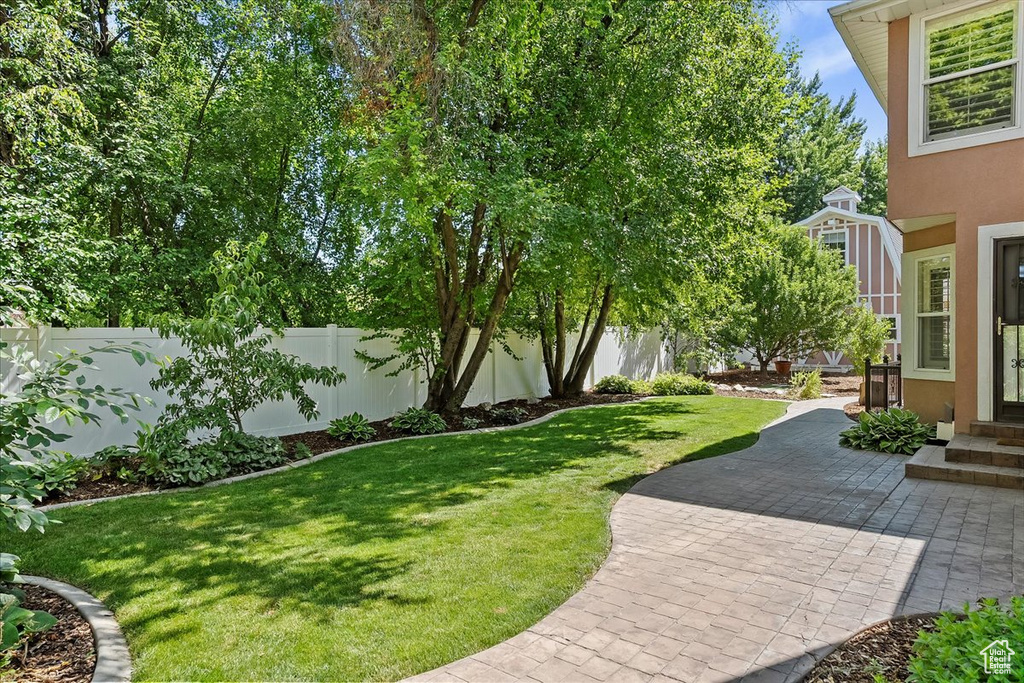 Fenced backyard featuring a patio