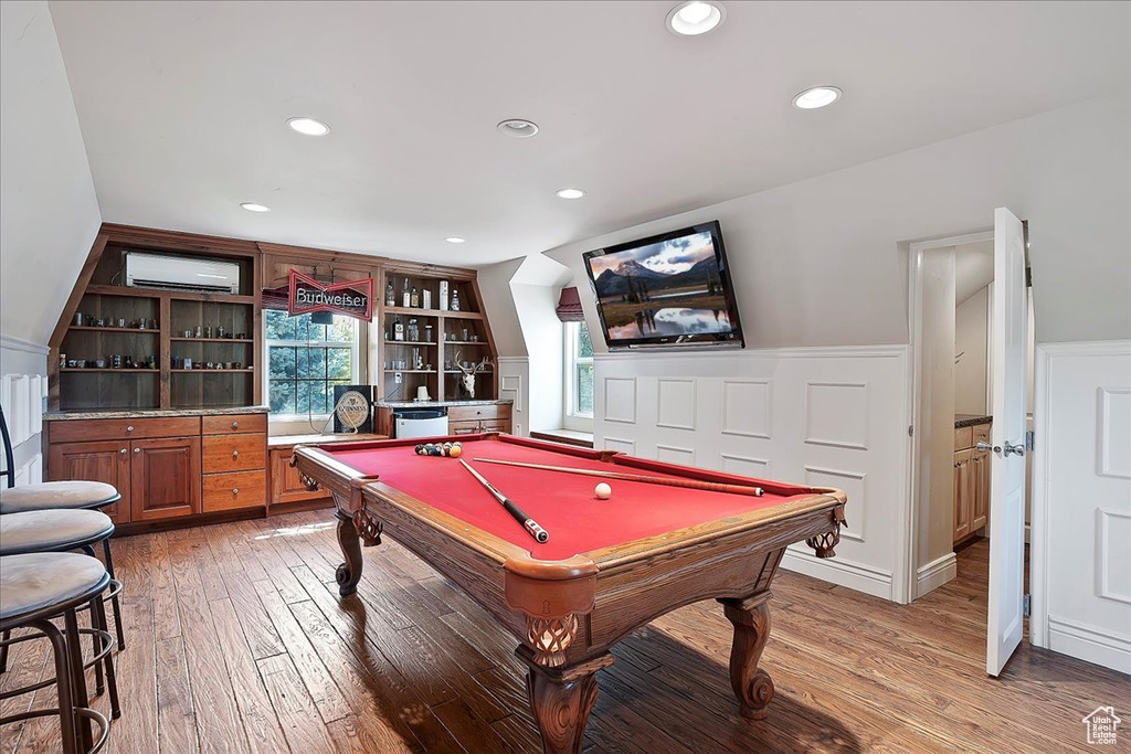 Playroom with a wainscoted wall, light wood finished floors, billiards table, an AC wall unit, and recessed lighting