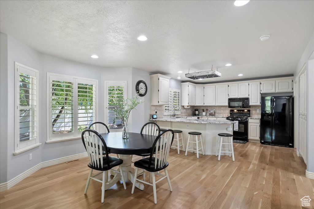 Dining room featuring light wood-style floors and recessed lighting