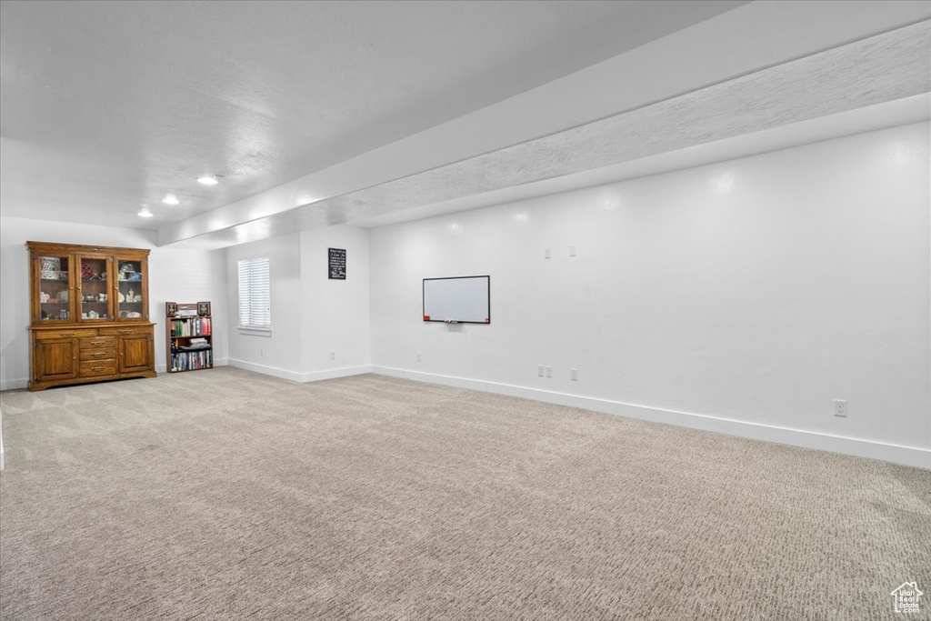 Unfurnished living room with light carpet and recessed lighting