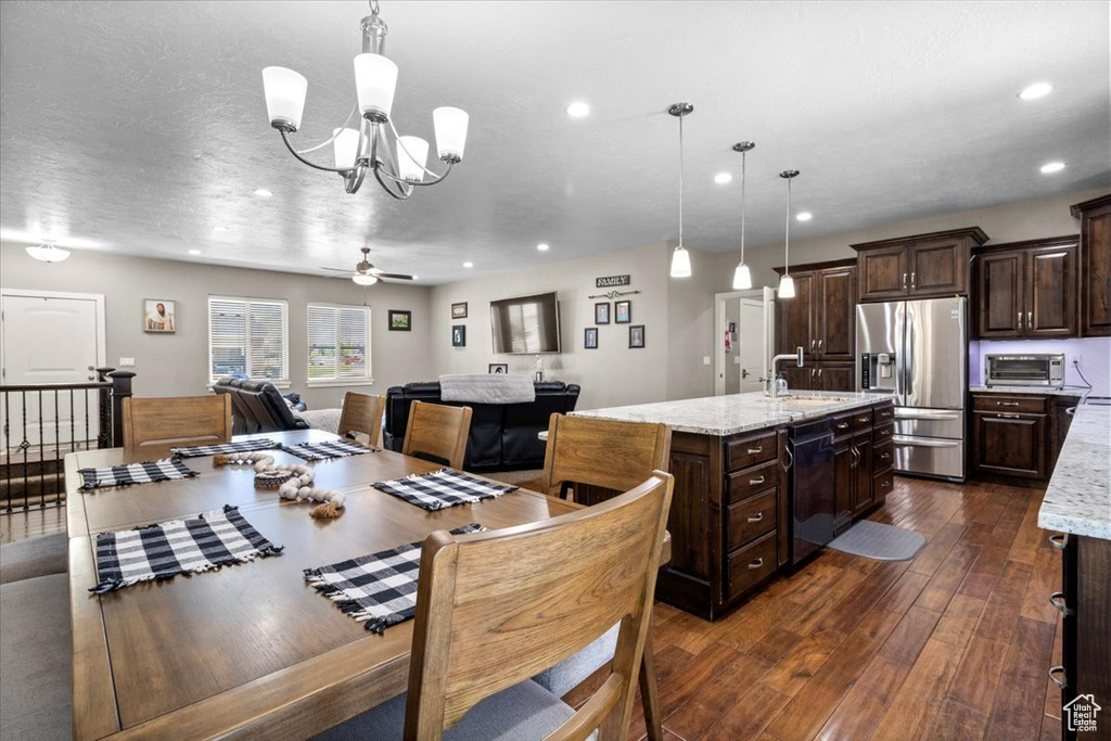 Dining area featuring dark wood-style flooring, a chandelier, a ceiling fan, and recessed lighting