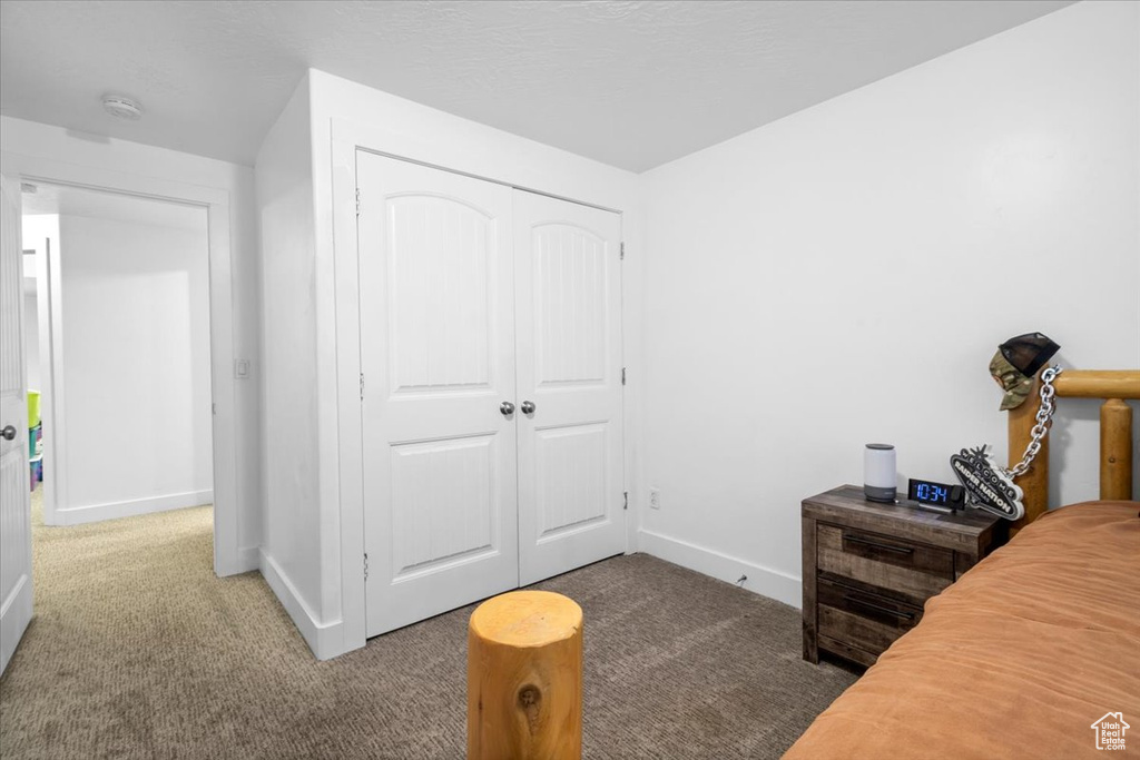 Bedroom with carpet and a closet
