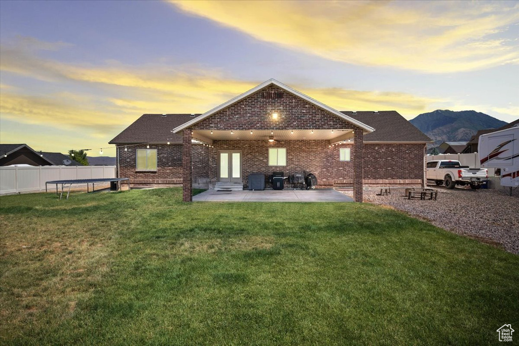 Rear view of house with brick siding and a patio