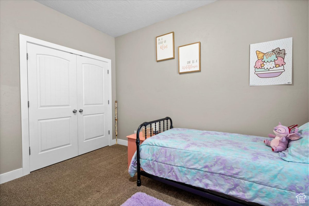Bedroom with carpet floors and a closet