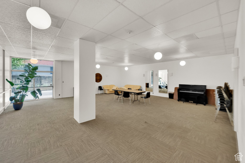 Basement featuring carpet flooring and a paneled ceiling