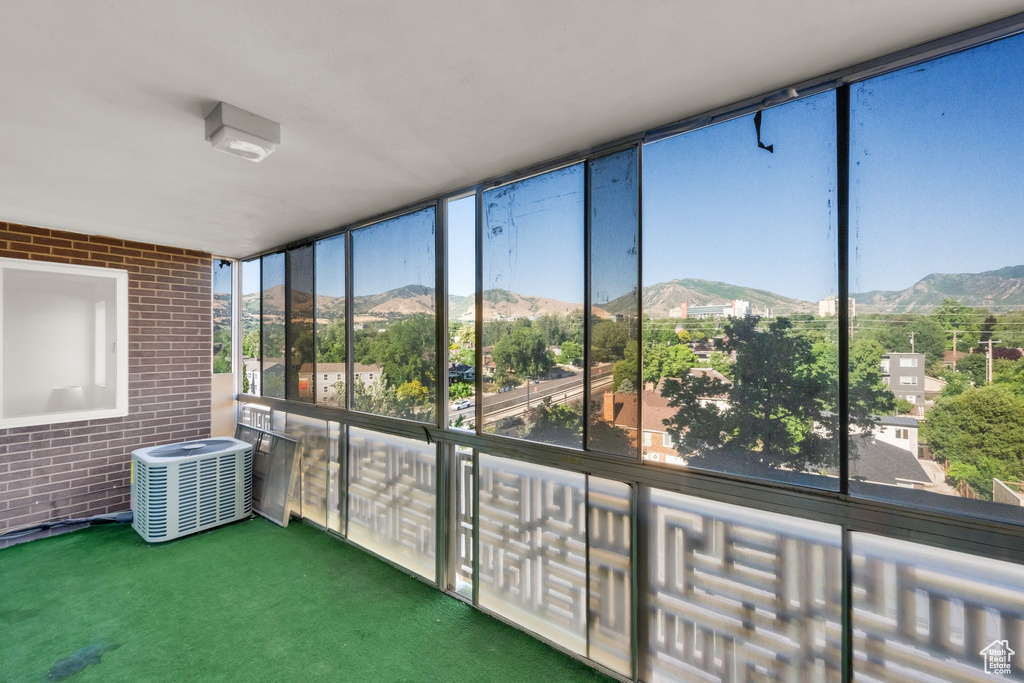 Unfurnished sunroom with a mountain view