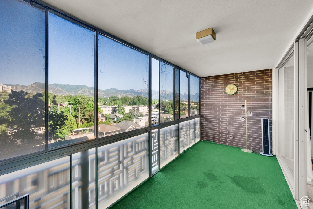 Unfurnished sunroom with a mountain view