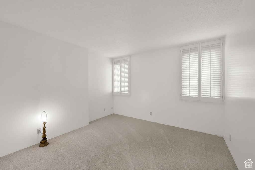 Spare room featuring carpet flooring