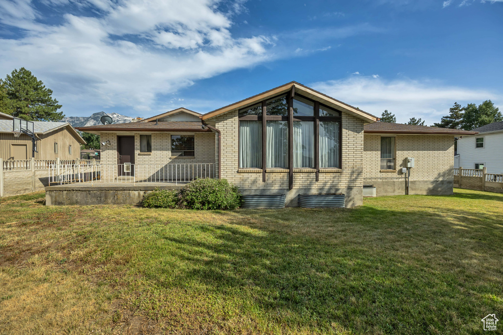 Rear view of property featuring brick siding