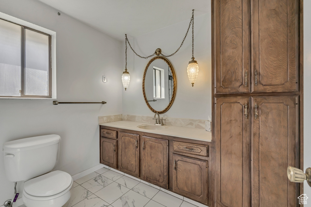 Bathroom with marble finish floors and vanity